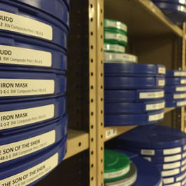 Film reels stacked on shelves 